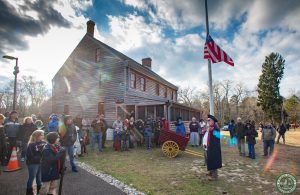 group forms around flag in front yard