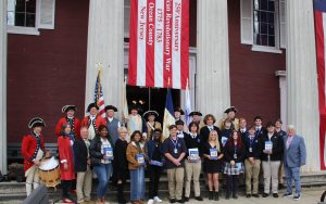 Students and speakers stand in front of 1850 Court House