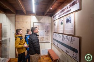 man and two children read displays