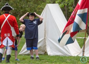 young male tries on tricorn-er hat