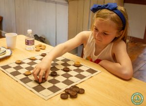 young female guest plays checkers
