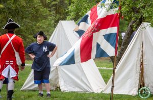 young man with tricorn-er hat at tent display