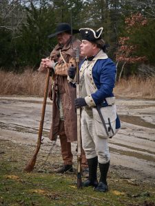 two period soldiers pose with weapons