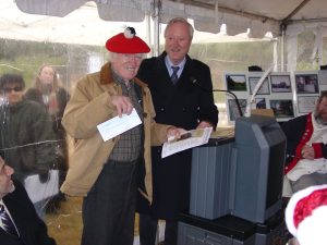 Mr. Koenig accepts check from John Bartlett Jr.