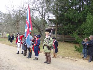 troops line up in front of tavern