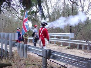 Period Soldiers fire over bridge