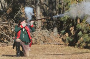 Jagger kneels and fires