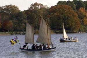 Two replica whale boats simulating encounter at sea