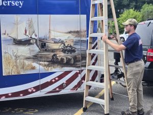 Joseph unfolds ladder at Monmouth parade