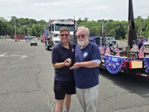 Tim presents challenge coin to Ted at Monmouth parade