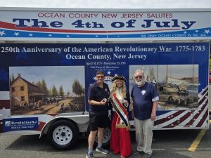 Monmouth County Clerk Christine G. Hanlon and Ted Maturo receive Ocean County challenge coins from Tim Hart