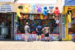 Visitors playing a balloon dart game on the Seaside Heights Boardwalk